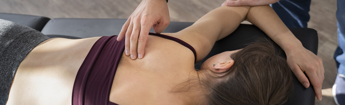 physiotherapist helping woman